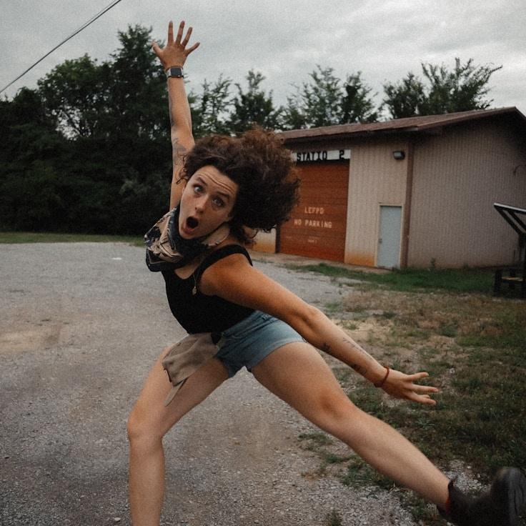 Avery Singh, Lead Design Curator at Primrose & Co., reviewing corporate floral arrangements